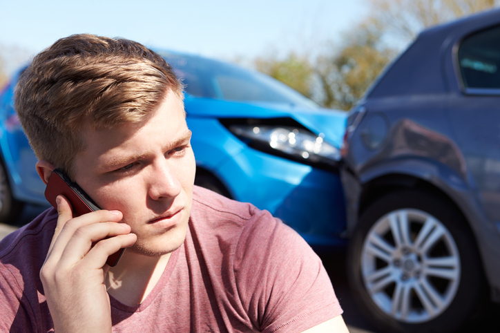 man on his phone after an accident - How long does a car accident settlement take?