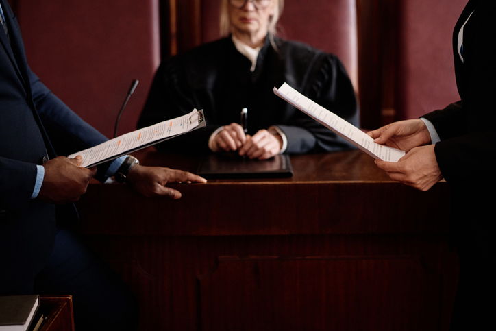 Close-up of lawyers holding juridical documents in front of a judge - how do trial lawyers compare to settlement lawyers personal injury